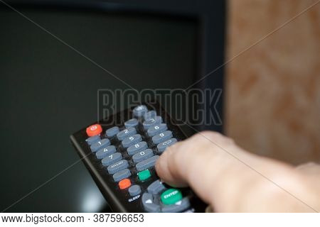 Tv Remote Control With Buttons In A Person's Hand