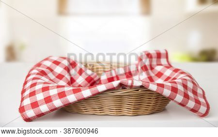 Wicker Basket With Red Checkered Tablecloth Inside On The Table