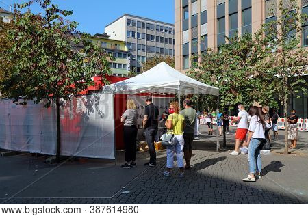 Dusseldorf, Germany - September 19, 2020: People Wait In Line For A Covid-19 (coronavirus) Temporary