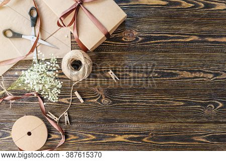 Craft Paper And Tools For Creating And Decorating Gift Packaging. There Is Cardboard, Brown Ribbons 