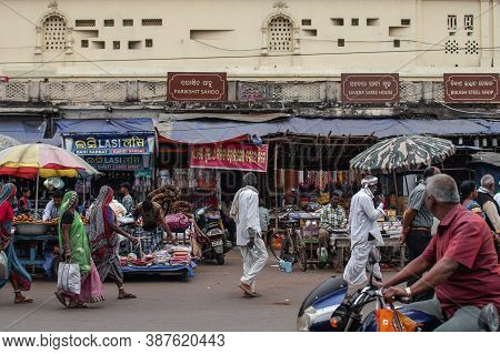 Puri, India - February 3, 2020: Unidentified People Walks By A Street Market With Food, Clothes And 