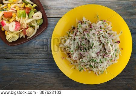 Salad Daikon, Onions And Dill On Blue Grey Wooden Background. Salad On Yellow Plate With Vegetarian 