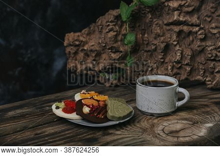 Chocolates With Dried Fruits And A Cup Of Espresso Coffee.