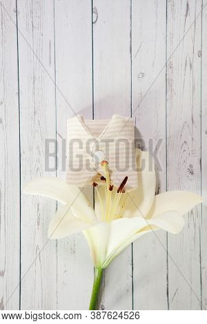 Cloth Menstrual Pad. Reusable Cloth Daily Pad With Lily Flower On Gray Wooden Background. Zero Waste