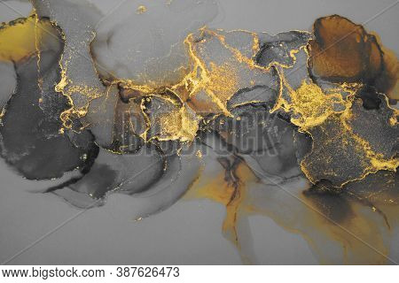 Art Abstract watercolor flow blot painting. Black and gold Color canvas marble texture background. Alcohol ink.