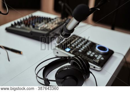 Working Place Of Radio Host. Close Up Of Headphones, Microphone And Sound Mixing Desk On The Table I