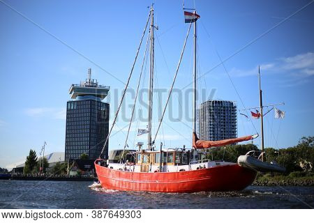 Red Ship In A Body Of Water