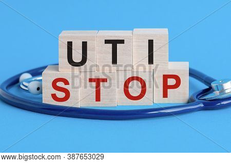 Wooden Block With Words Uti Stop - Urinary Tract Infection - With Stethoscope On The Table, Insuranc