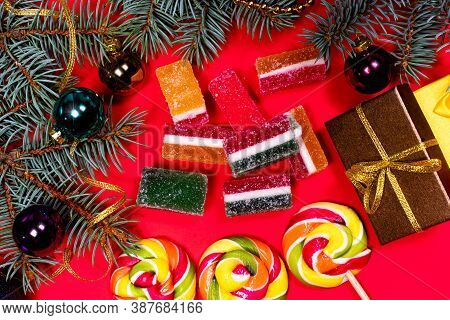 Leneds On A Stick And Marmalade On A Red Background. Banner For Confectionery With Christmas Decorat