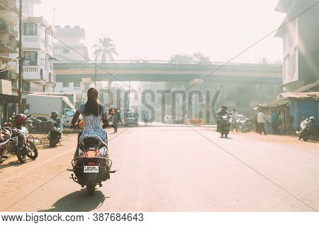 Margao, Goa, India - February 16, 2020: Woman Driver Riding On Scooters Motorcycle On Street In Sunn