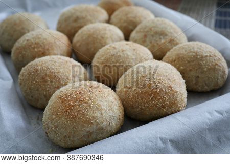 Fresh Baked Filipino Pandesal On Parchment Paper.