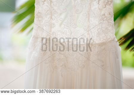 Close-up Of The Texture Of The Pattern Of The Brides Dress At The Waist Of The Dress.
