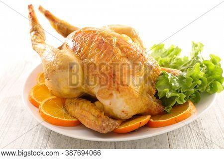 grilled whole chicken with orangle slices