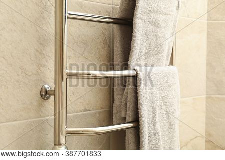 Modern Heated Towel Rail On Tiled Bathroom Wall
