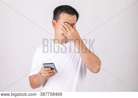 Eyestrain Concept. Man Touching His Eyes Because Pain Or Hurt After Using Too Much Smartphone. Studi