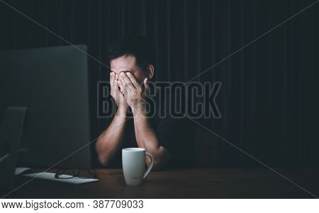 Eyestrain Concept. Man Touching His Eyes Because Tired After Working Long Time On Computer