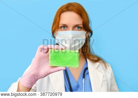 Doctor In A Medical Mask With A Bar Of Soap In His Hand On A Blue Background, Portrait
