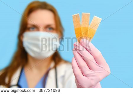 Woman Doctor Holding A Patch On A Blue Background, Close-up.