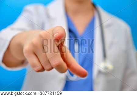 The Doctor Points His Finger Forward At You, Close-up On A Blue Background. The Nurse Gestures With 
