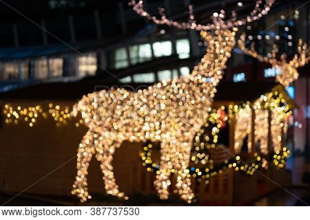 Blurred Lights Of Christmas Installation - Defocused Lights Of Deer On Night City Background. Christ
