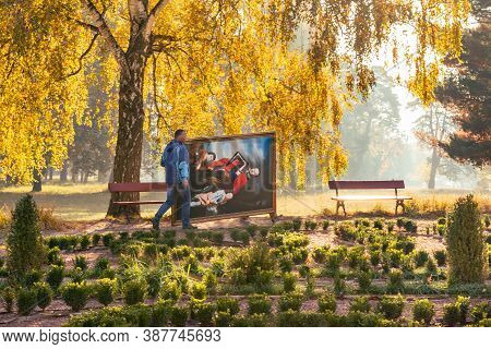 Belaya Tserkov, Ukraine, October 17, 2019: Two Men Carry Painting In The Morning In The Autumn Park.