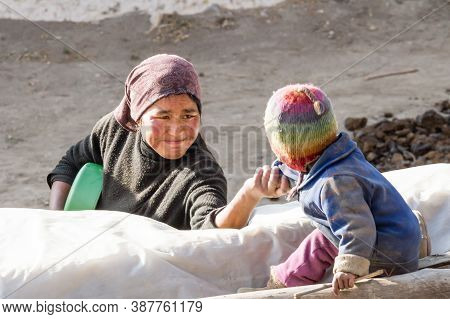 Jhong, Nepal - November 17, 2015: Mother Is Calling Little Nepali Child Playing Near The House.
