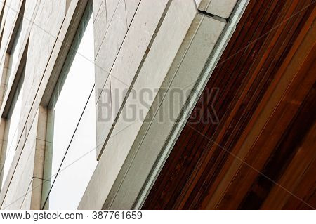 Modern Facade Cladding With Stone And Ceiling Paneling With Wood