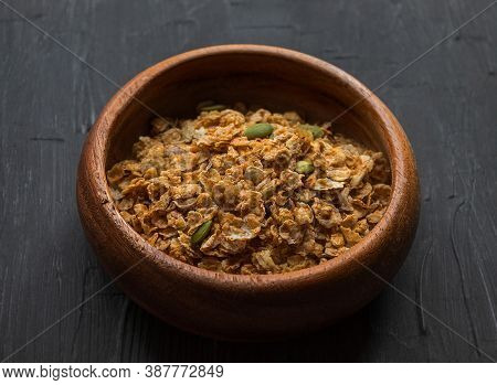 Multi-glier Muesli With Flax And Pumpkin Seeds Lie In A Wooden Plate