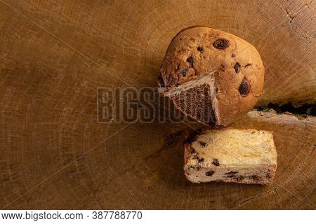 Panettone With Chocolate Chips On Rustic Wood, Top View