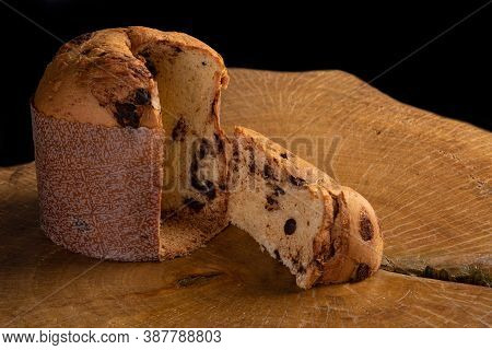 Panettone With Chocolate Chips On Rustic Wood With Black Background, Selective Focus.