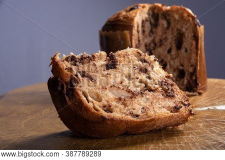 Panettone With Chocolate Chips On Rustic Wood With Gray Background, Selective Focus.