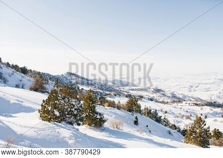 Snowy Slopes Covered With Snow In Sunny Weather. Winter Landscape In The Mountains Of The Beldersay 