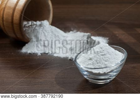 Baking Soda (sodium Bicarbonate) On Dark Wooden Background.
