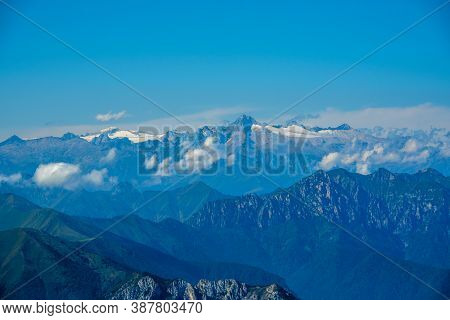 The Peaks Of The Alps Around Lake Garda Surrounded By Fog With Blue Sky Seen From Monte Altissimo, T
