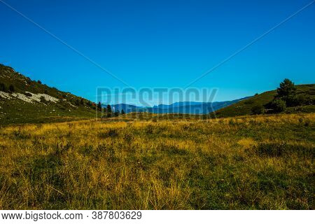 The Peaks Of The Alps Around Lake Garda Surrounded By Fog With Blue Sky Seen From Monte Altissimo, T