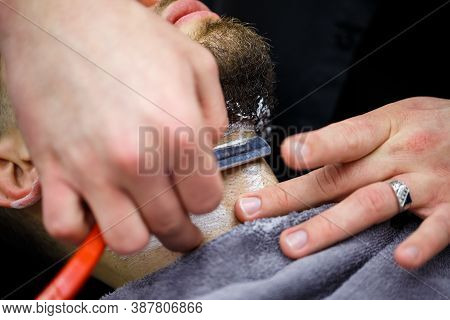 Trimting A Beard In A Barbers Salon To A Man