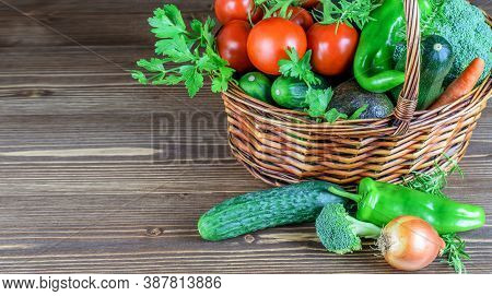 Basket Ful Of Assorted Vegetables On The Wooden Background. Gardening, Harvest Time Concept.