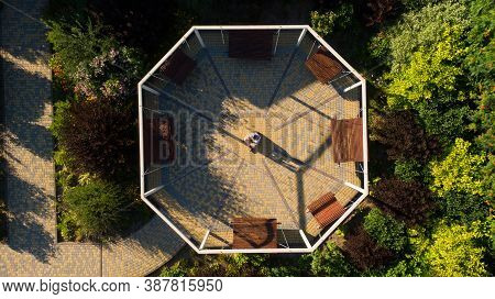 Place In Apark With Bences In A Round.
