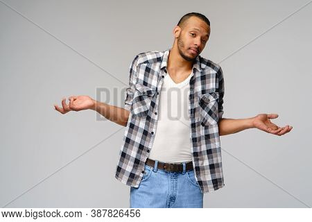 I Dont Know Gesture - Young Afrcian American Man Over Grey Background Being At A Loss, Showing Helpl