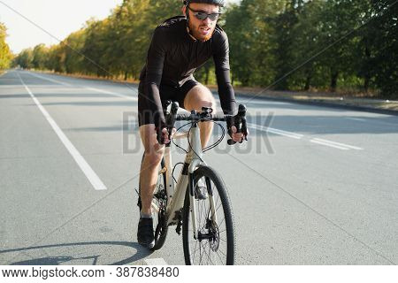 Close-up Image Of A Road Cyclist On A Gravel Bike. Bicycle Training Outdoors, Modern Looking Bike An