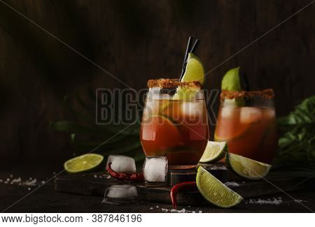 Michelada - Mexican Alcoholic Cocktail With Beer, Lime Juice, Tomato Juice, Spicy Sauce And Spices, 