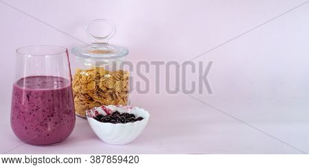 Smoothies Of Berries And Cornflakes On A Pink Background