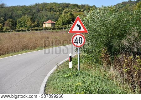 Road Signs That Shows Maximum Speed Of 40 Kilometers Per Hour And Signa That Warns Drivers On Sharp 