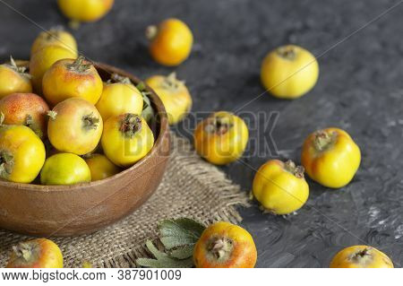Fresh Ripe Yellow/red Hawthorn Fruits In Wooden Bowl On Rustic Background. Crataegus Monogyna Berrie