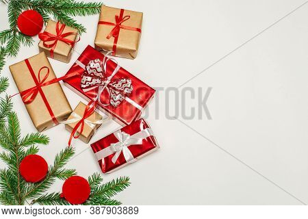 Christmas Composition, Fir Branches With Gifts, Red Decorations On A Vertical White Surface, Space F