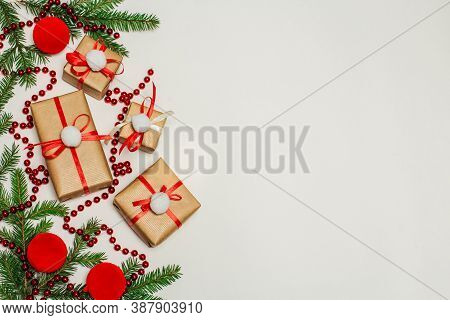 Christmas Composition. Gifts, Fir Branches, Red Ornaments. Winter, New Year's Concept. Flat Layout, 
