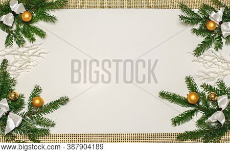 Christmas Composition With Fir Branches And Golden Ornaments Balls In A Frame With Space For Text