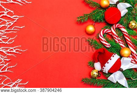 Christmas Composition. Gifts, Fir Branches And Cones, Gold Jewelry, Caramel On A Red Background, New