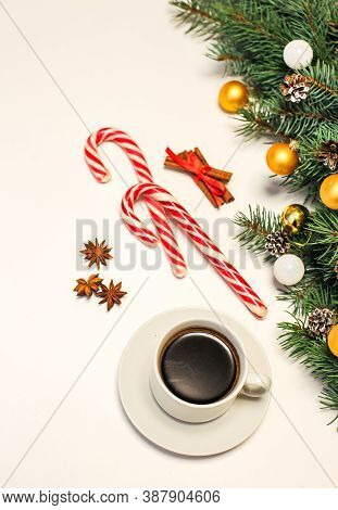 Christmas Layout With A Cup Of Coffee On The Table, Decorations, Fir Branches, Candy And Cinnamon. N