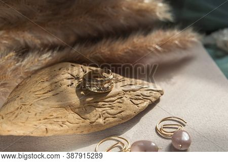 Trendy Vintage Cast Brass Ring. Jewelry Womens Ring Abstract Drawing Closeup On A Gray Natural Stone